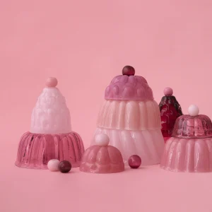Jello S Hand-blown Glass Cloche by Studio Berg, a group of pink and raspberry glass cloches on a pink background